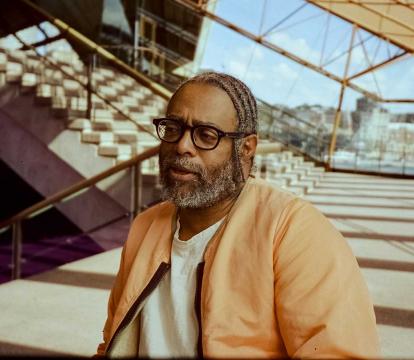 Man sat down in front of steps.
