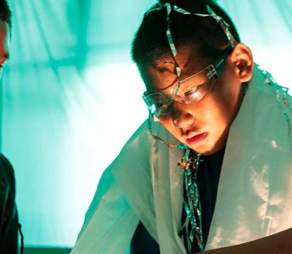 Young boys gathered around a skeleton.