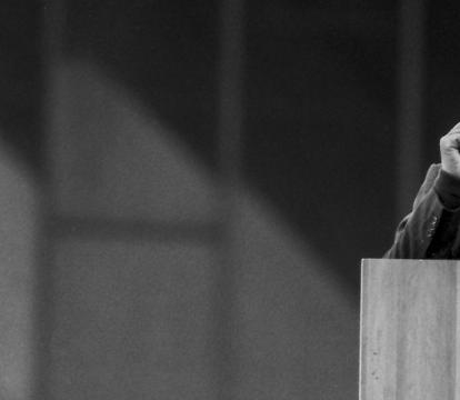 Former president of South Africa Nelson Mandela giving speech standing on a podium.