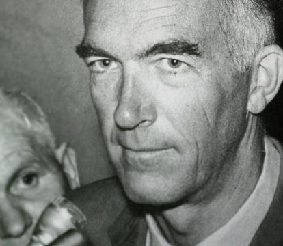 A close up of Jorn Utzon with a small smile on his face.