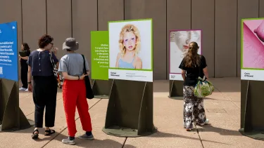 Audience members browse artworks outside the Opera House.
