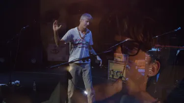 All three Malkmuses playing instruments on stage overlayed in the same image.