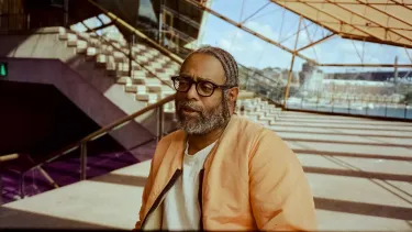 Man sat down in front of steps.