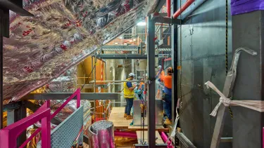 Builders renovating metal construction.