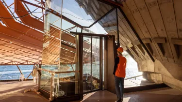 Builders standing in front of a glass structure at the Concert Hall.