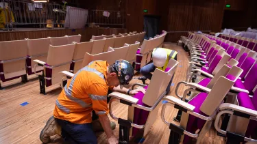 Builders fixing seats into place in the Concert Hall.