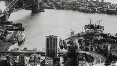 A view of city skyline and Sydney opera house under construction.