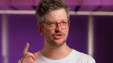 A man reading from a book.