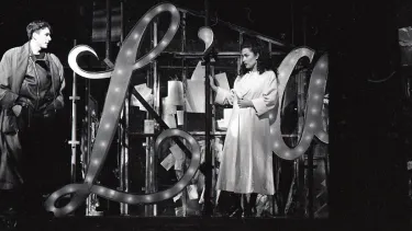 A man and a woman performing Opera on the stage.
