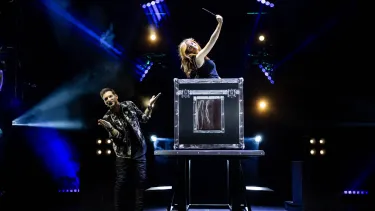 Now You See Me Live Magicians on stage, popping out of a box after dissapearing
