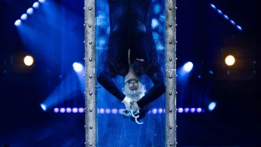 Now You See Me Live Magician entering a water cell to perform an escape trip underwater.