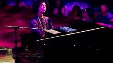 A man playing the piano on stage.