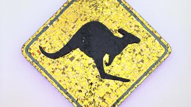 A colorful mosaic sign featuring a kangaroo, showcasing intricate tile work and vibrant patterns.