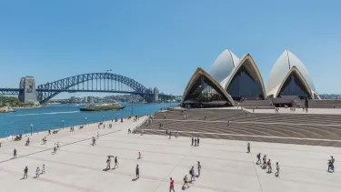 A long shot of Sydney opera house and the Harbour bridge on a sunny day.