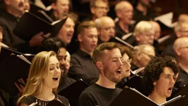 A choir singing with books in their hands.